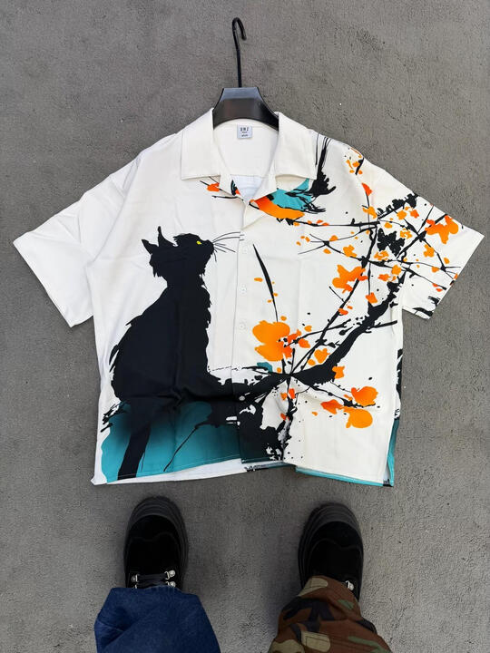 Short-sleeve button-up shirt with artistic abstract print. Lightweight, breathable, and designed for elevated casual and summer wear.