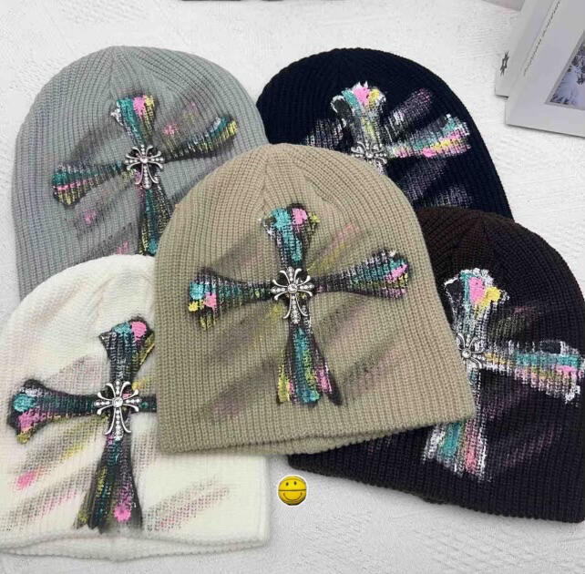 Classic knit beanie finished with multicolor cross embroidery. Adds a bold accent to everyday outfits and cold-weather styling.